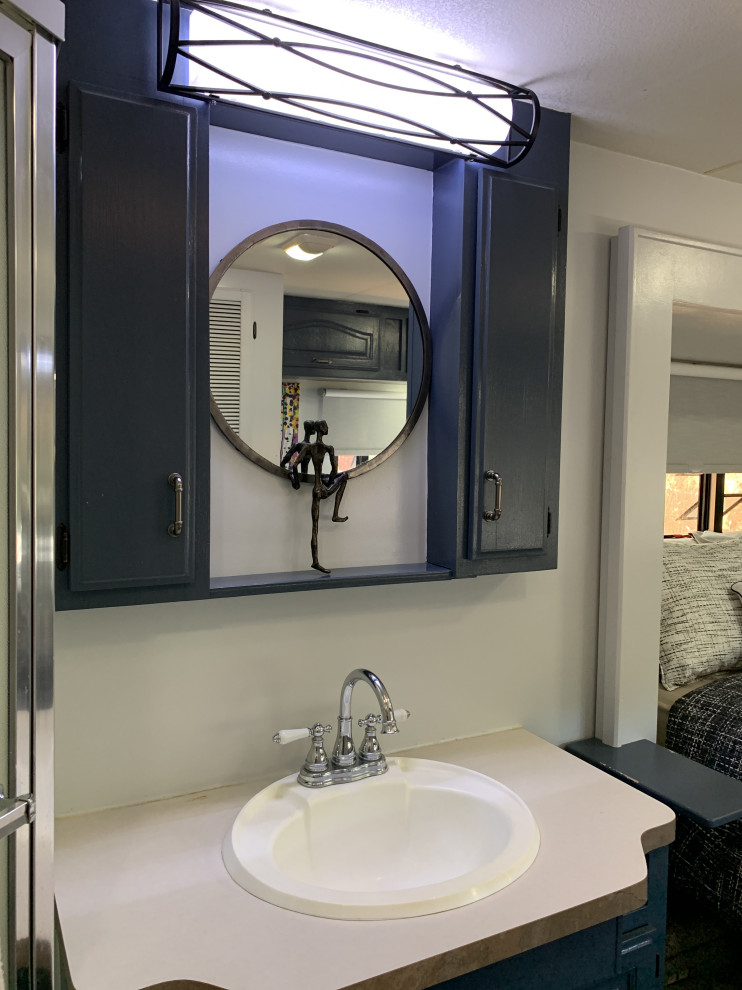 Свежая идея для дизайна: маленькая ванная комната со стиральной машиной в стиле фьюжн с фасадами с выступающей филенкой, синими фасадами, угловым душем, серыми стенами, полом из ламината, душевой кабиной, накладной раковиной, столешницей из ламината, серым полом, душем с распашными дверями, бежевой столешницей, тумбой под одну раковину и встроенной тумбой для на участке и в саду - отличное фото интерьера