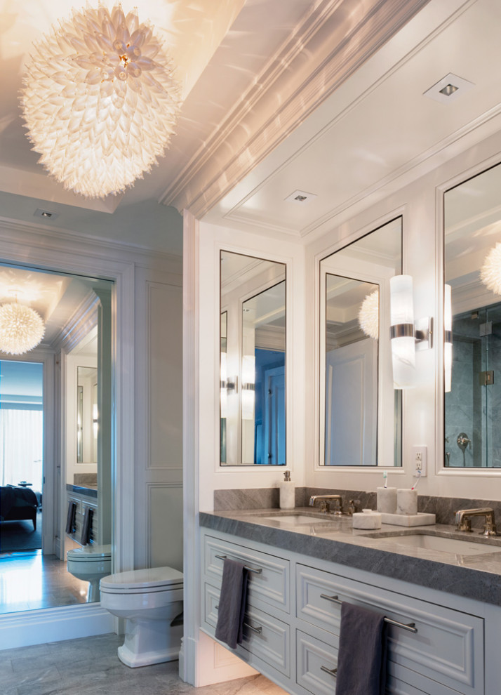 Photo of a mid-sized contemporary powder room in New York with shaker cabinets, white cabinets, a one-piece toilet, an undermount sink, granite benchtops and a built-in vanity.