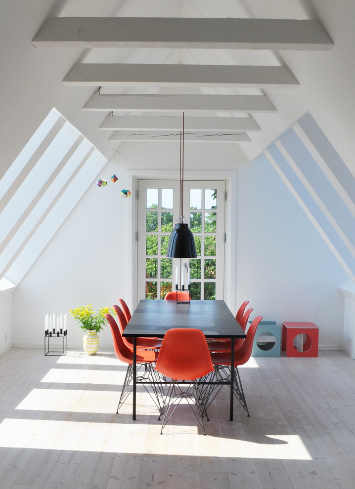 Inspiration for a mid-sized scandinavian separate dining room in Copenhagen with white walls and light hardwood floors.
