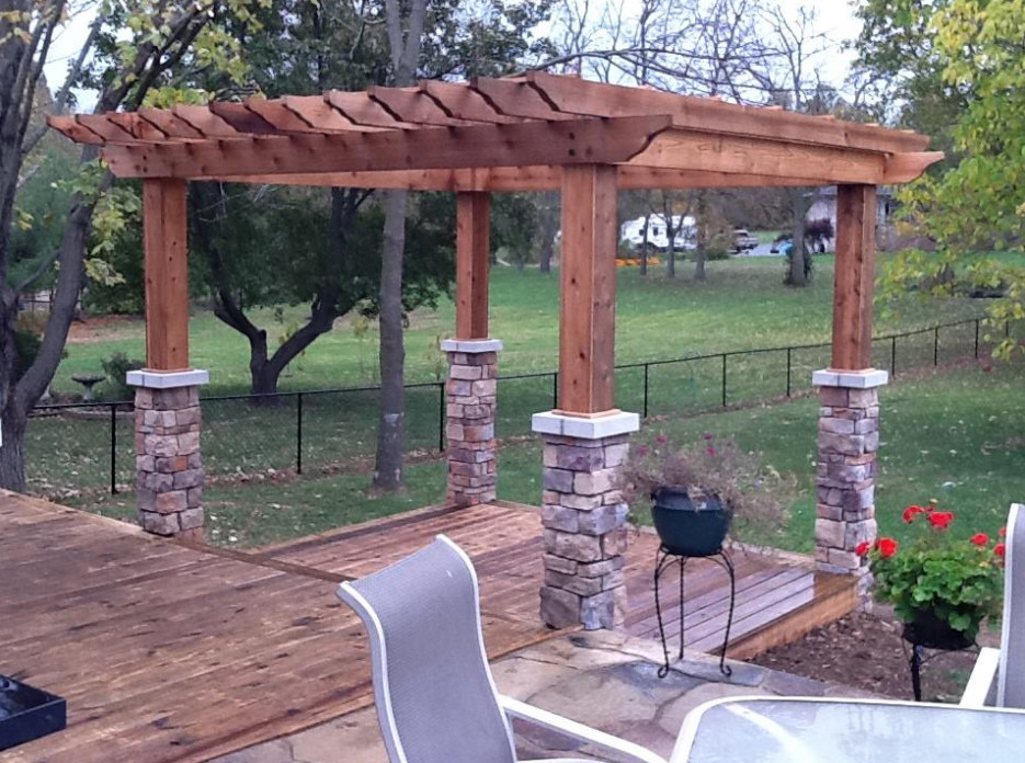 Example of a mid-sized backyard outdoor kitchen deck design with a pergola