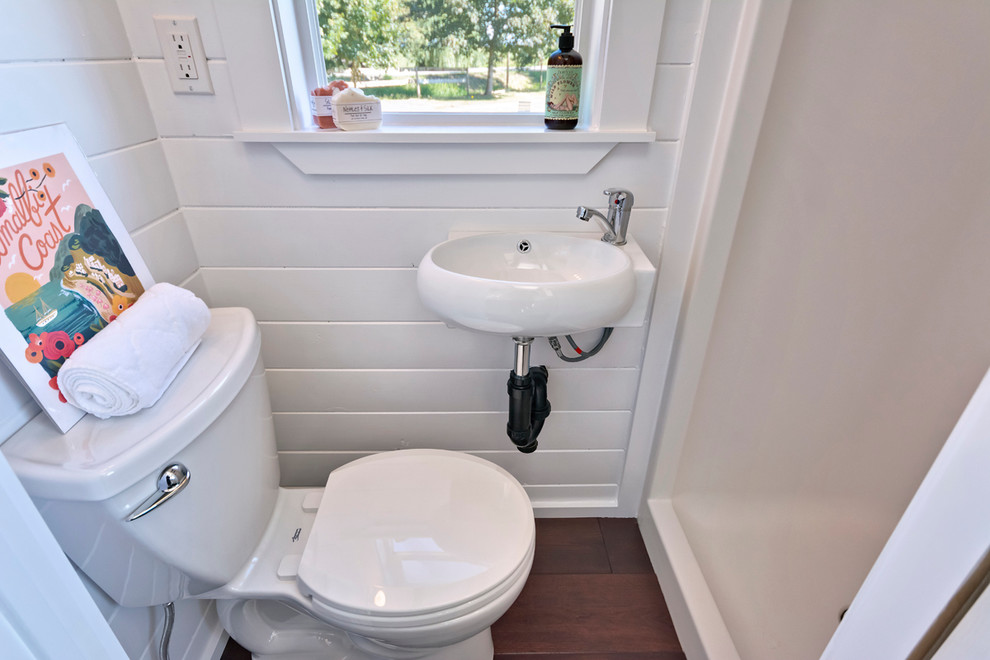 Inspiration for a small beach style bathroom in Vancouver with an alcove shower, a one-piece toilet, white walls, dark hardwood floors and a wall-mount sink.