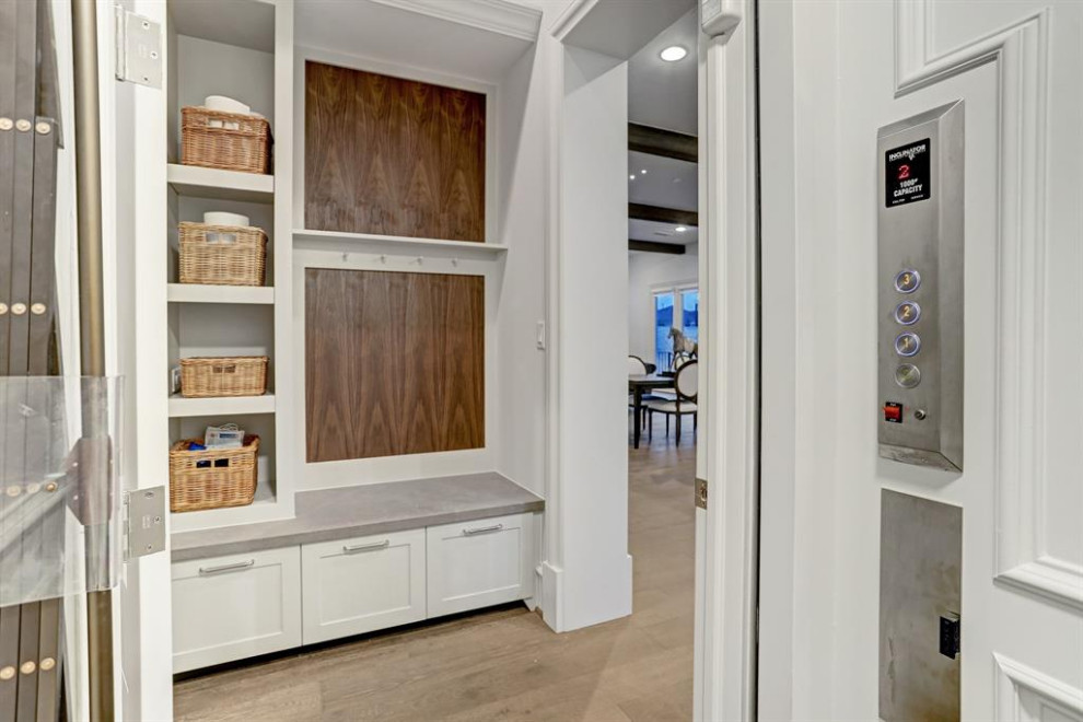 Inspiration for a huge transitional u-shaped light wood floor and brown floor enclosed kitchen remodel in Houston with a farmhouse sink, shaker cabinets, gray cabinets, quartz countertops, gray backsplash, brick backsplash, stainless steel appliances, an island and gray countertops