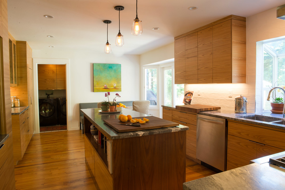 Example of a mid-sized transitional u-shaped medium tone wood floor eat-in kitchen design with an undermount sink, flat-panel cabinets, medium tone wood cabinets, quartzite countertops, white backsplash, ceramic backsplash, stainless steel appliances and an island
