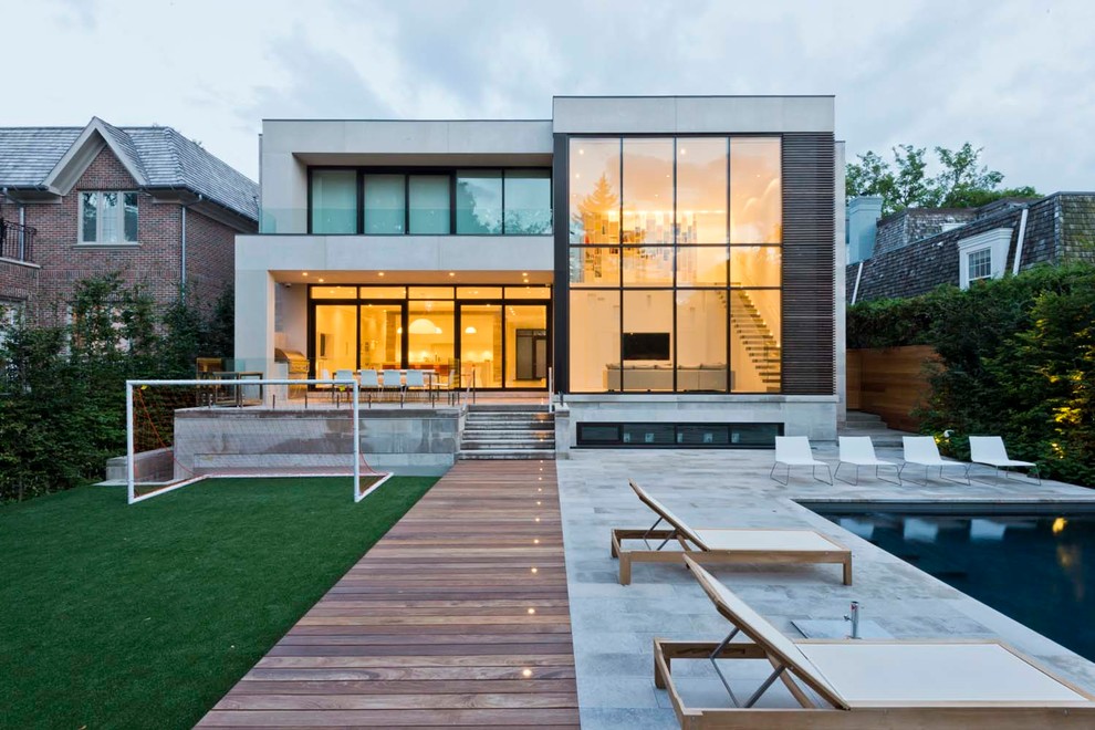 Inspiration for a modern two-storey white exterior in Toronto with a flat roof.