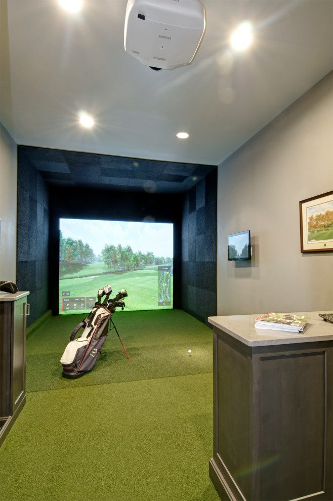 Photo of a mid-sized enclosed home theatre in Columbus with grey walls, a projector screen and green floor.