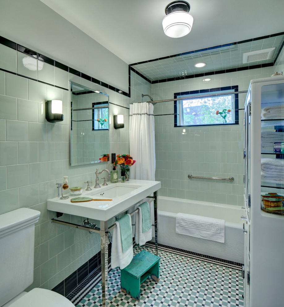 This is an example of a mid-sized arts and crafts bathroom in Los Angeles with glass-front cabinets, yellow cabinets, an alcove tub, a shower/bathtub combo, a two-piece toilet, green tile, subway tile, green walls, mosaic tile floors, a console sink, turquoise floor and a shower curtain.