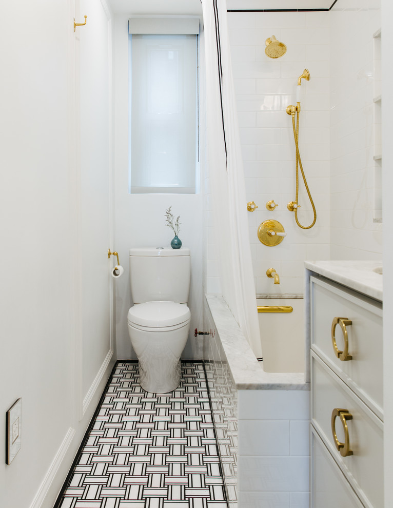 Photo of a mid-sized transitional 3/4 bathroom in Tampa with white cabinets, a shower/bathtub combo, white tile, white walls, an undermount sink, a shower curtain, an undermount tub, a one-piece toilet, ceramic tile, ceramic floors, marble benchtops, black floor and white benchtops.