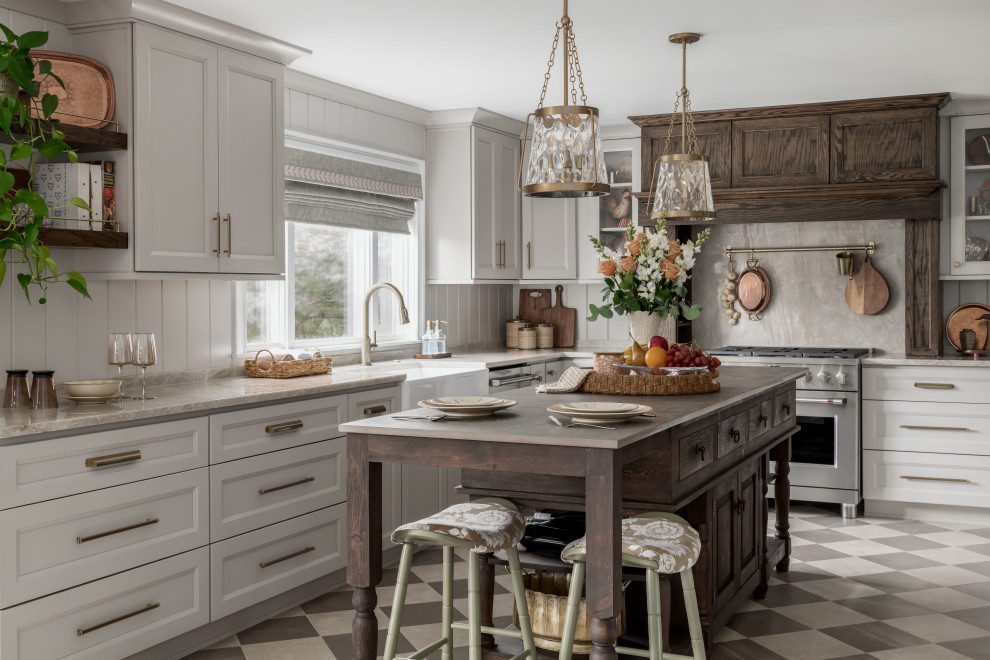 Inspiration for a mid-sized timeless u-shaped porcelain tile and beige floor eat-in kitchen remodel in Philadelphia with a farmhouse sink, shaker cabinets, beige cabinets, quartzite countertops, beige backsplash, wood backsplash, stainless steel appliances, an island and beige countertops