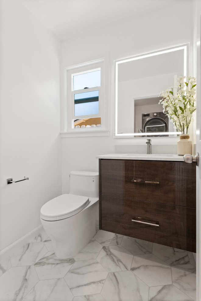 Example of a small minimalist gray tile and marble tile marble floor, gray floor and single-sink bathroom design in San Francisco with flat-panel cabinets, brown cabinets, a one-piece toilet, white walls, an undermount sink, marble countertops, gray countertops and a floating vanity