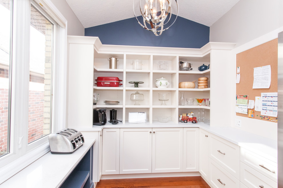 Example of a large transitional u-shaped dark wood floor and brown floor kitchen pantry design in Toronto with recessed-panel cabinets, white cabinets, quartz countertops, gray backsplash, stainless steel appliances, an island and white countertops