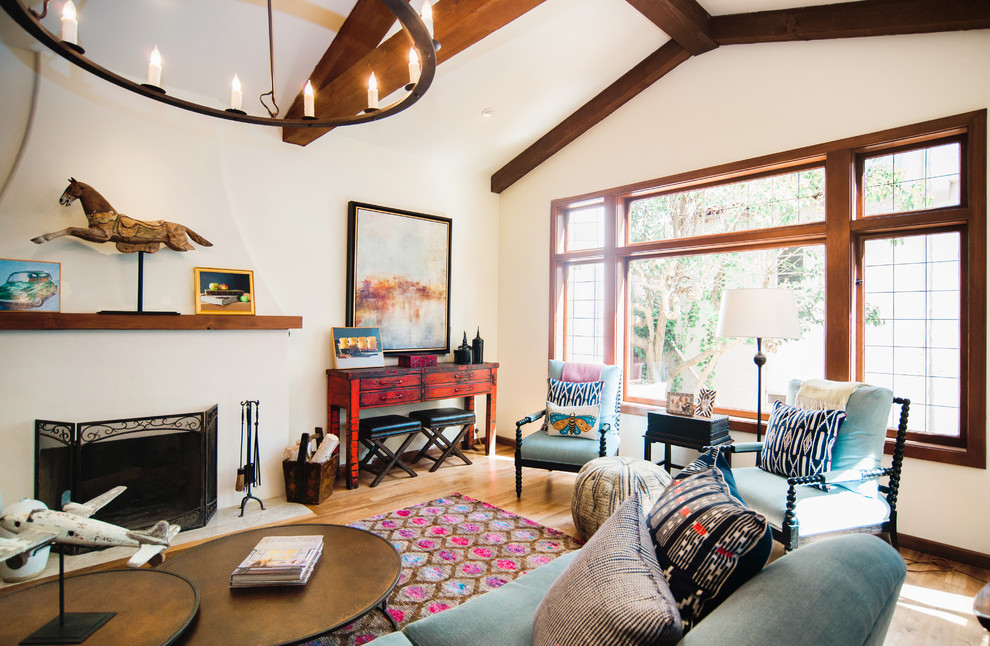 Photo of a large arts and crafts open concept living room in San Francisco with white walls, light hardwood floors, a standard fireplace, a concrete fireplace surround and beige floor.