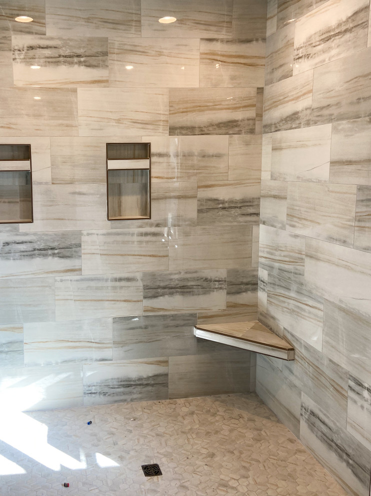 Huge beige tile and porcelain tile porcelain tile and beige floor doorless shower photo with beige walls and a niche