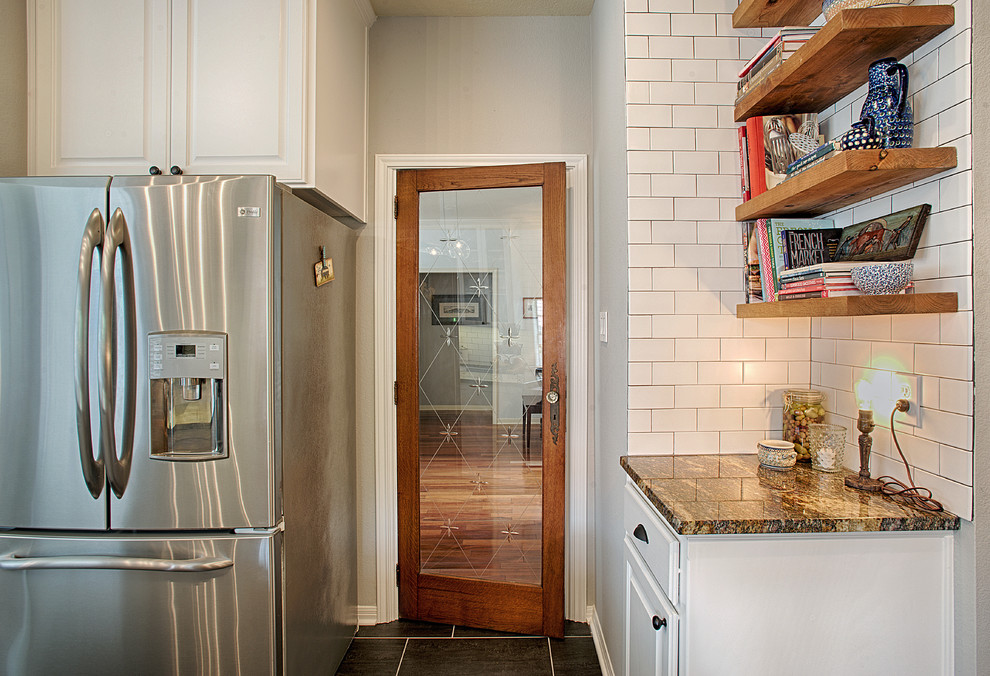 Mid-sized traditional single-wall eat-in kitchen in Austin with an undermount sink, raised-panel cabinets, white cabinets, white splashback, subway tile splashback, stainless steel appliances, painted wood floors and with island.