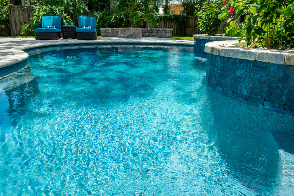 This is an example of a mid-sized tropical pool in Jacksonville.