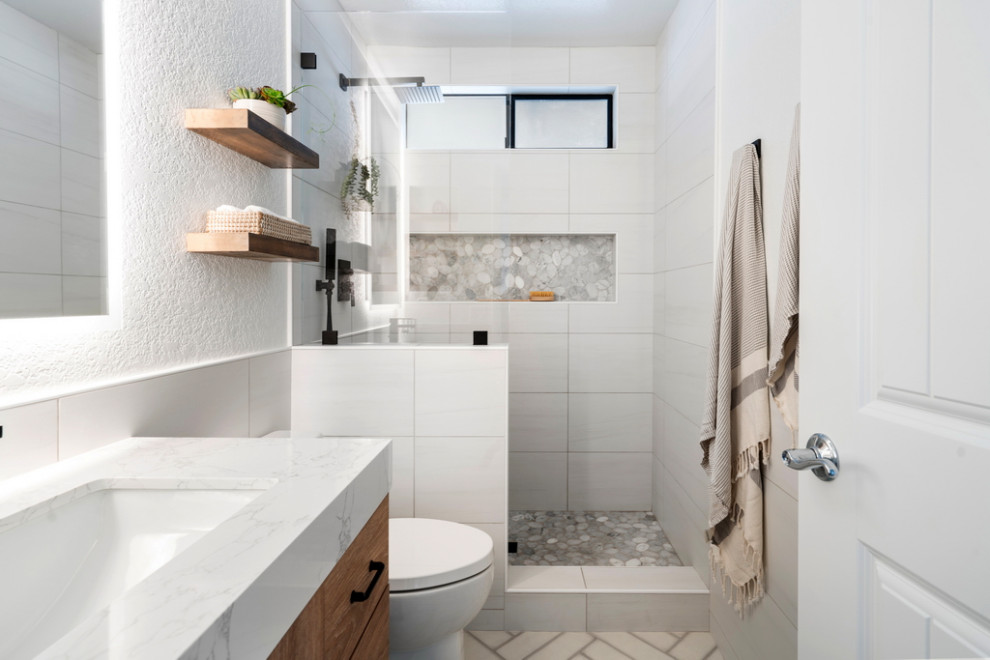 Design ideas for a small beach style master bathroom in Other with flat-panel cabinets, medium wood cabinets, an alcove shower, a one-piece toilet, white tile, ceramic tile, ceramic floors, an undermount sink, quartzite benchtops, white floor, an open shower, white benchtops, a single vanity and a freestanding vanity.