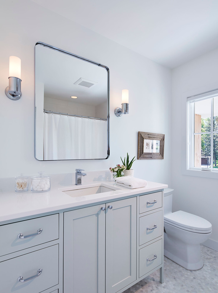 Mid-sized scandinavian 3/4 bathroom in Minneapolis with grey cabinets, a two-piece toilet, white walls, marble floors, an undermount sink, white floor, shaker cabinets, an alcove tub, a shower/bathtub combo, white tile, subway tile, quartzite benchtops and a shower curtain.