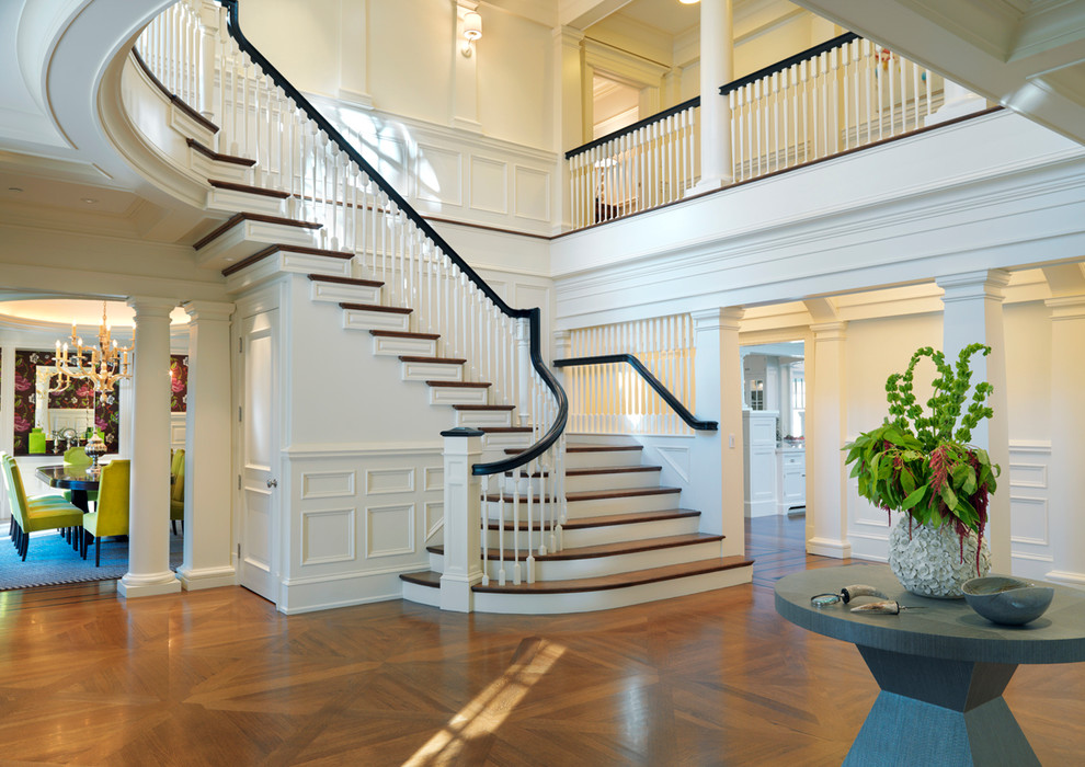 Design ideas for a traditional foyer in Boston with white walls and medium hardwood floors.