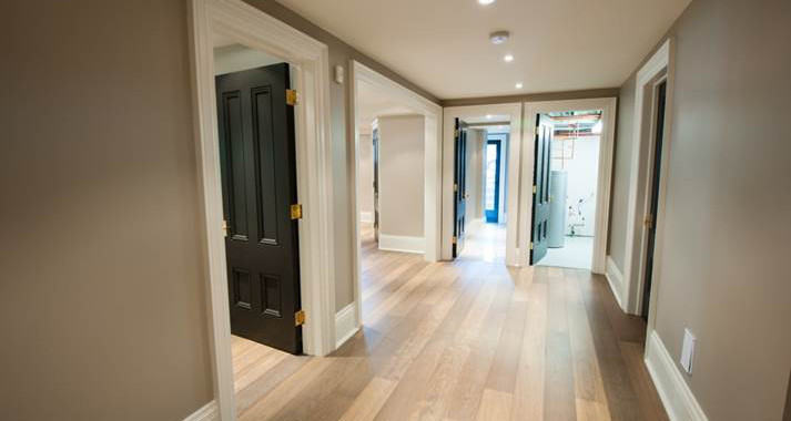 This is an example of a mid-sized contemporary hallway in Toronto with brown walls and medium hardwood floors.