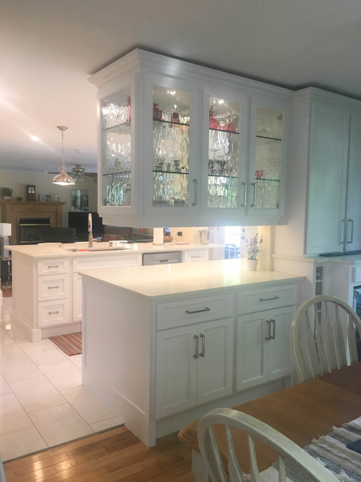 Eat-in kitchen - mid-sized transitional u-shaped porcelain tile and gray floor eat-in kitchen idea with an undermount sink, shaker cabinets, white cabinets, quartz countertops, stainless steel appliances, a peninsula and beige countertops