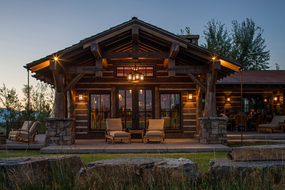 Patio - mid-sized rustic backyard concrete patio idea in Other with a roof extension