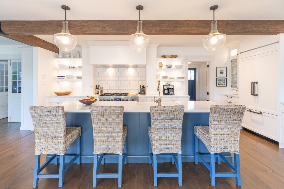 Open concept kitchen - transitional l-shaped medium tone wood floor and brown floor open concept kitchen idea with a farmhouse sink, shaker cabinets, white cabinets, white backsplash, paneled appliances, an island and multicolored countertops