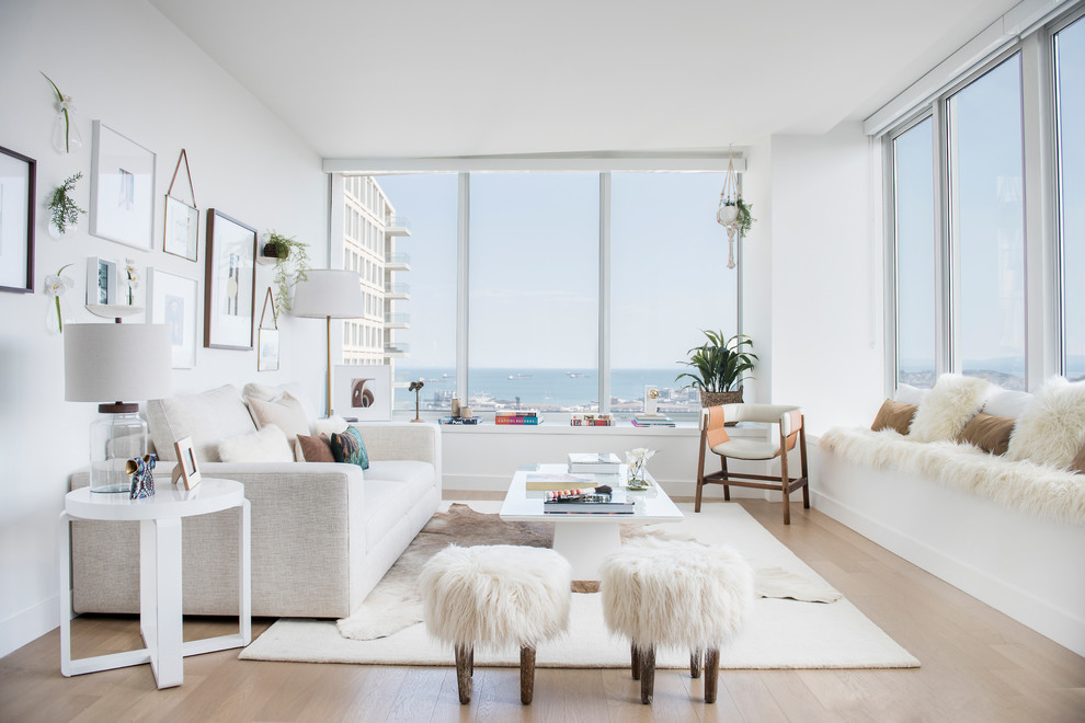 Mid-sized scandinavian formal open concept living room in Miami with white walls, light hardwood floors, no fireplace, no tv and beige floor.