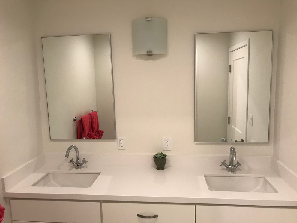 This is an example of a large contemporary kids bathroom in Other with shaker cabinets, white cabinets, an alcove tub, a shower/bathtub combo, a one-piece toilet, white tile, ceramic tile, white walls, ceramic floors, an undermount sink, engineered quartz benchtops, grey floor and a sliding shower screen.