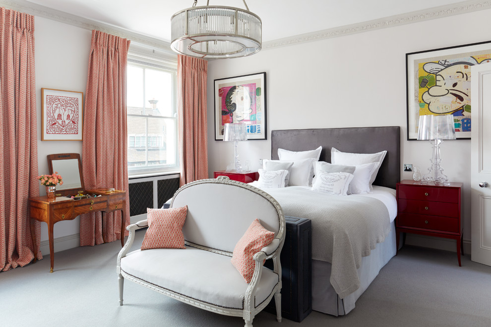 Inspiration for a mid-sized transitional master bedroom in London with white walls, carpet and no fireplace.