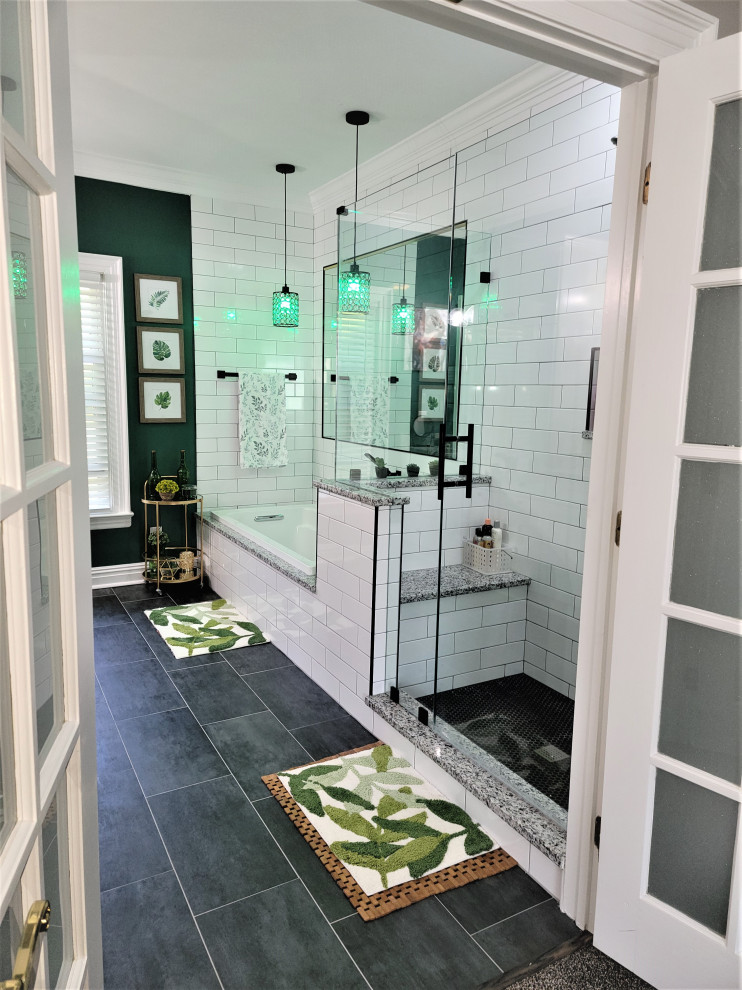 Photo of a mid-sized modern master bathroom in Richmond with shaker cabinets, grey cabinets, a drop-in tub, an alcove shower, a two-piece toilet, white tile, porcelain tile, green walls, porcelain floors, an undermount sink, granite benchtops, black floor, black benchtops, a niche, a double vanity and a freestanding vanity.