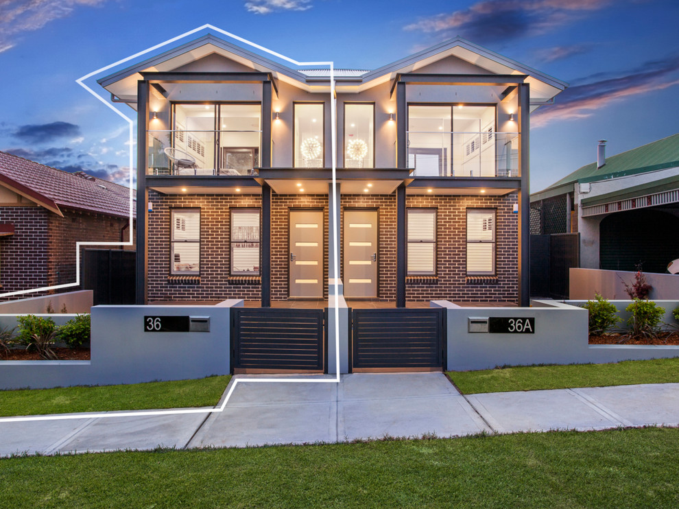 Mid-sized contemporary two-storey brick brown duplex exterior in Sydney with a metal roof.