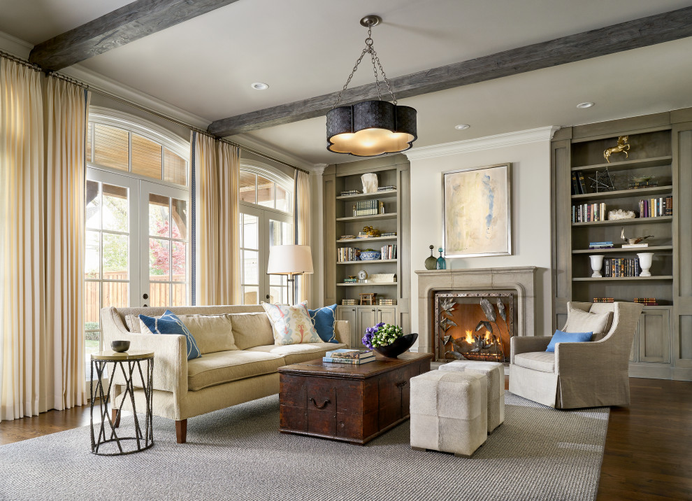 Photo of a transitional open concept living room in Dallas with grey walls, medium hardwood floors, a standard fireplace, a stone fireplace surround, a wall-mounted tv, brown floor and exposed beam.
