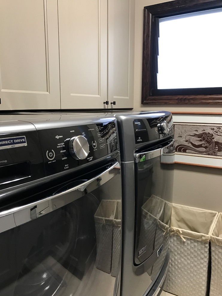Inspiration for a mid-sized tropical u-shaped dedicated laundry room in Hawaii with an undermount sink, recessed-panel cabinets, grey cabinets, granite benchtops, grey walls, ceramic floors, a side-by-side washer and dryer, beige floor and grey benchtop.
