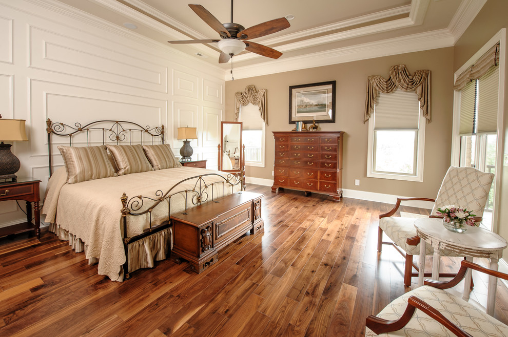Large transitional master medium tone wood floor and brown floor bedroom photo with brown walls and no fireplace