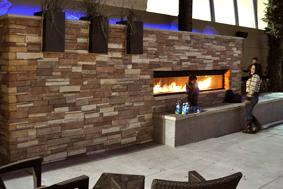 Design ideas for a large back patio in Austin with a fire feature, concrete slabs and no cover.