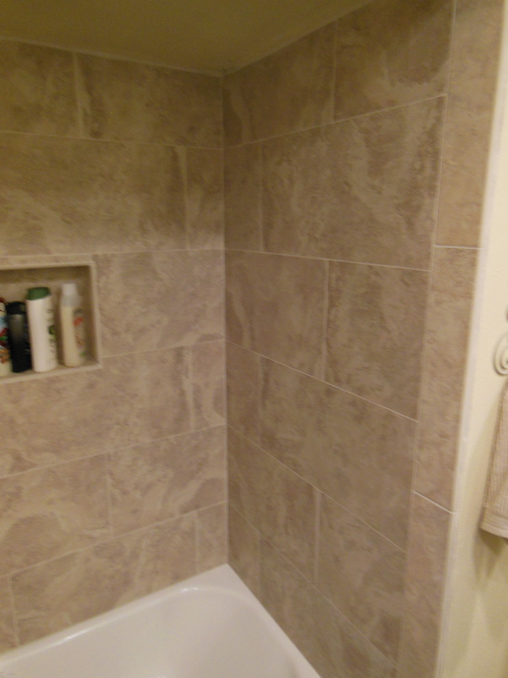 This is an example of a small traditional bathroom in Orange County with a drop-in tub, an open shower, beige tile, porcelain tile and porcelain floors.