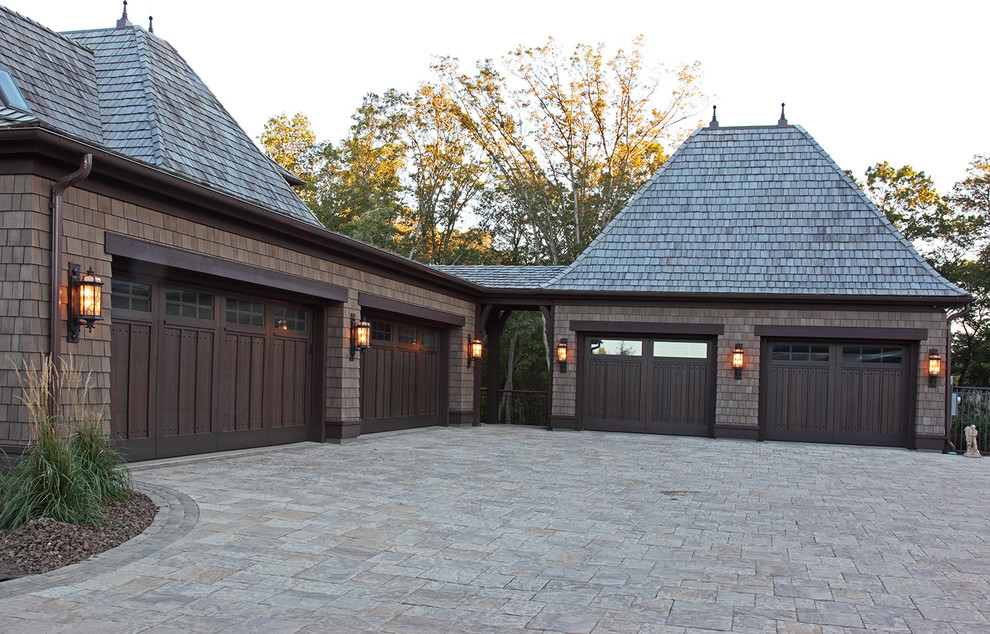 This is an example of a large country two-storey brown exterior in Minneapolis with wood siding and a hip roof.
