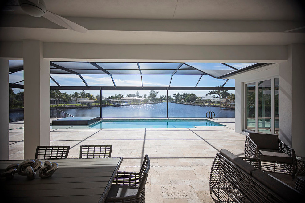 Large modern indoor rectangular pool in Miami with stamped concrete.