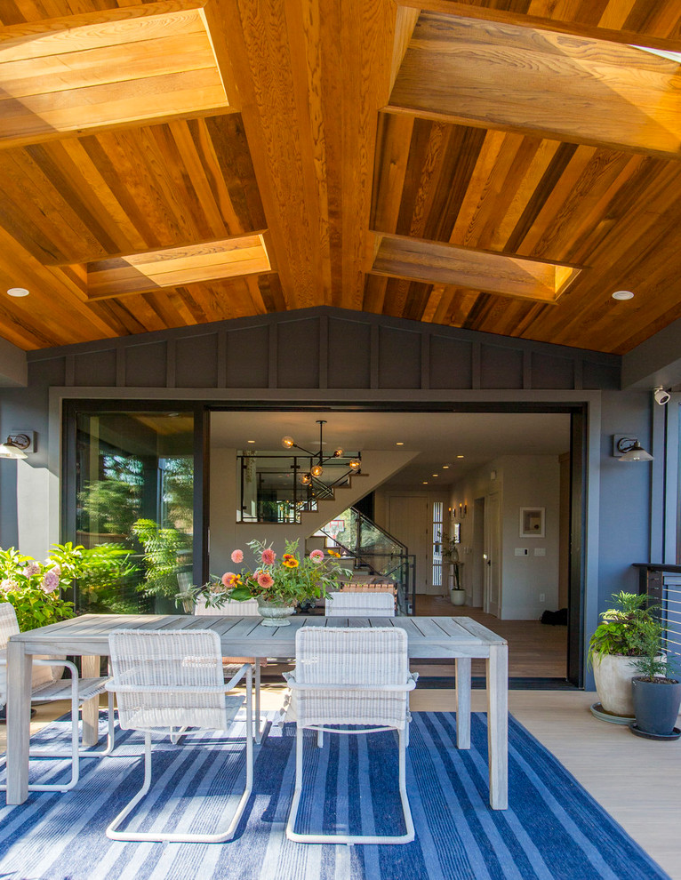 This is an example of a country backyard patio in San Francisco with a roof extension.
