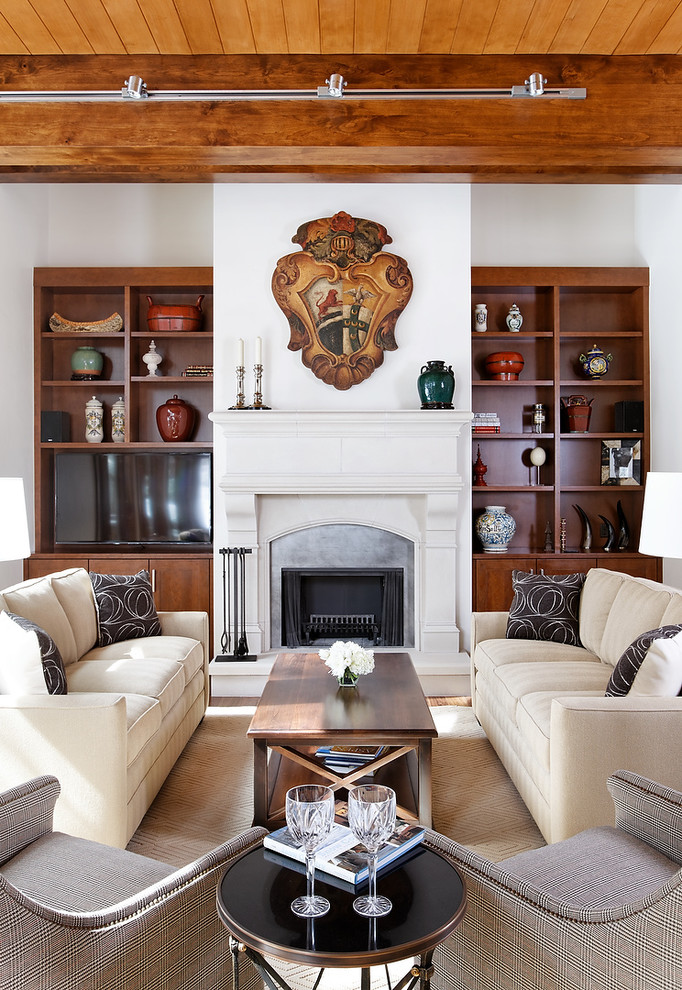 Traditional living room in Denver with white walls, a standard fireplace and a built-in media wall.