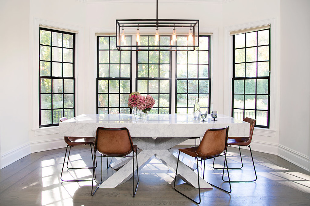 Transitional dining room in New York with white walls, medium hardwood floors and brown floor.