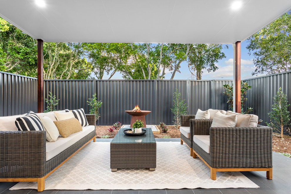 Photo of a contemporary patio in Brisbane with tile and a roof extension.