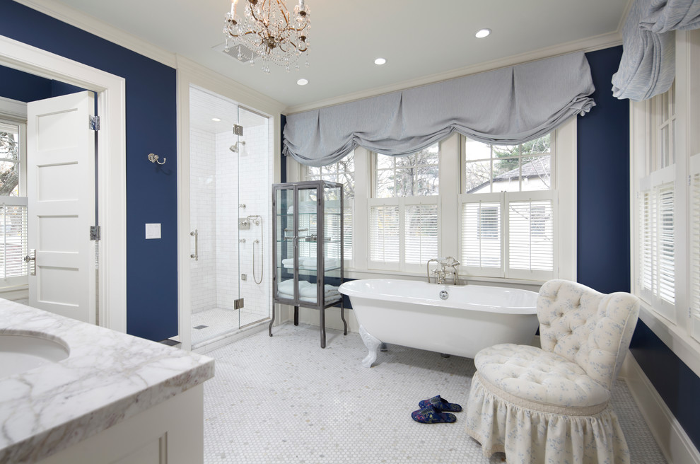 Design ideas for a traditional bathroom in Minneapolis with a claw-foot tub and marble benchtops.