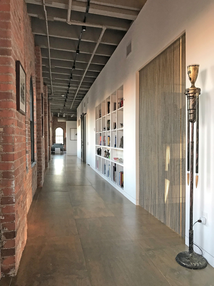 Industrial hallway in Cleveland with white walls, concrete floors and grey floor.