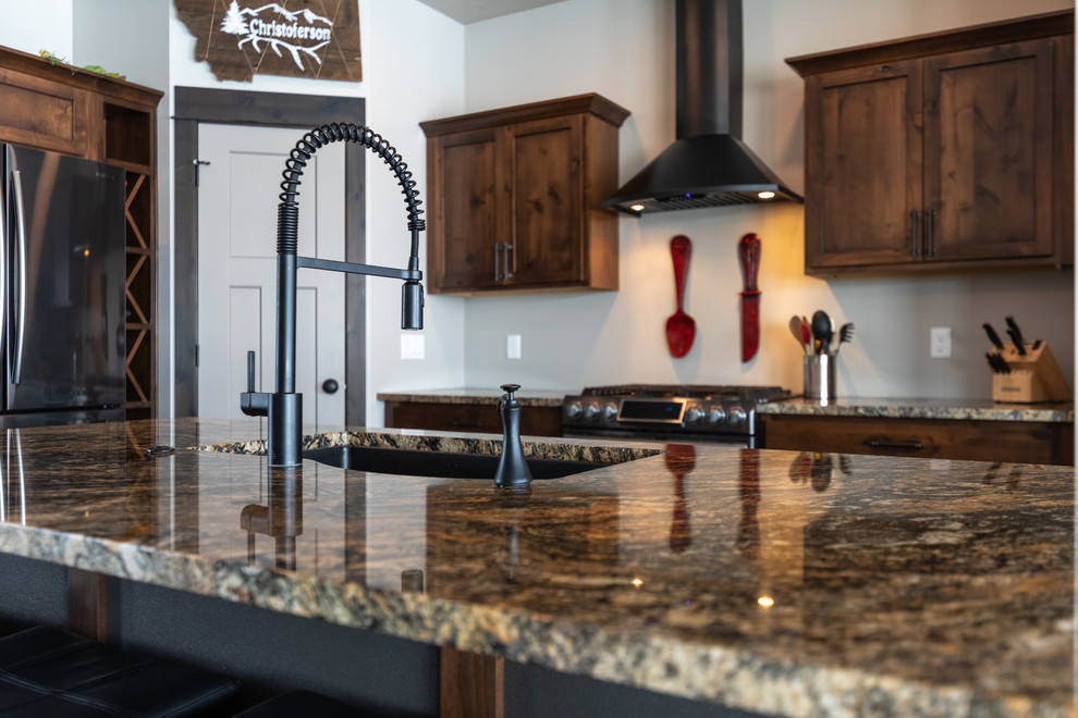 Mid-sized transitional l-shaped medium tone wood floor and brown floor eat-in kitchen photo with an undermount sink, shaker cabinets, medium tone wood cabinets, granite countertops, stainless steel appliances, an island and beige countertops