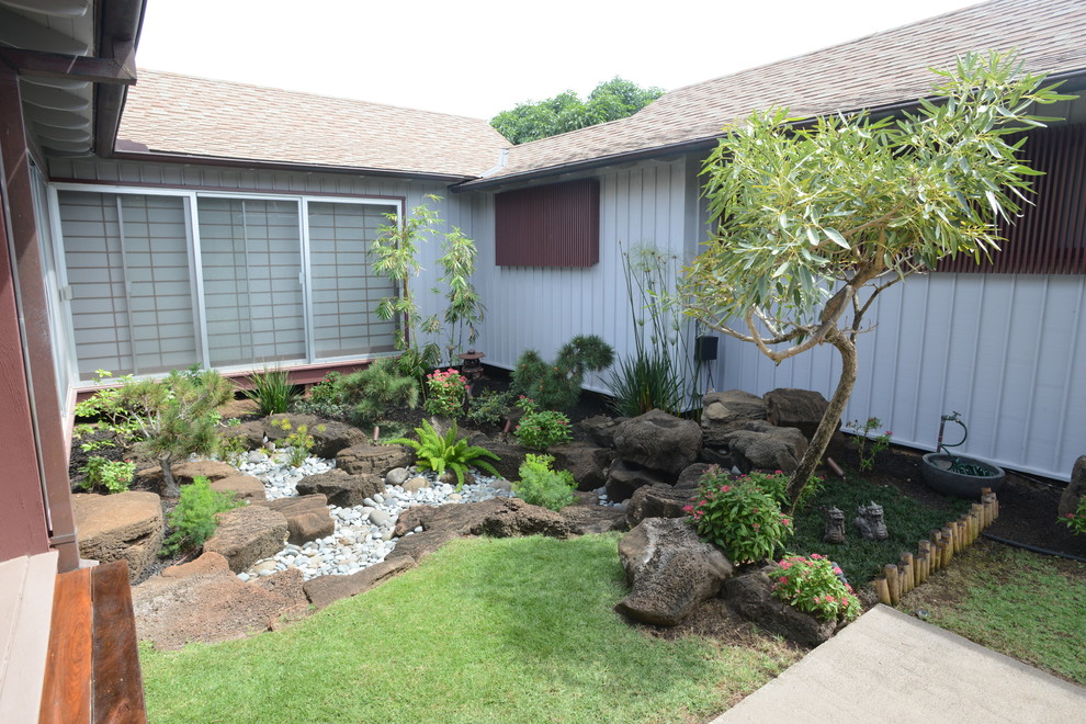 Inspiration for a mid-sized asian side yard partial sun formal garden for summer in Hawaii with a water feature and decking.
