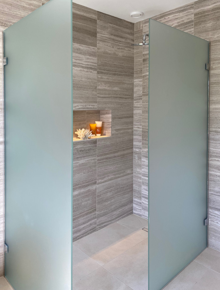 Small contemporary kids wet room bathroom in Hampshire with flat-panel cabinets, brown cabinets, a wall-mount toilet, brown tile, limestone, porcelain floors, a console sink, laminate benchtops, brown floor, an open shower, brown benchtops, a niche, a single vanity and a floating vanity.