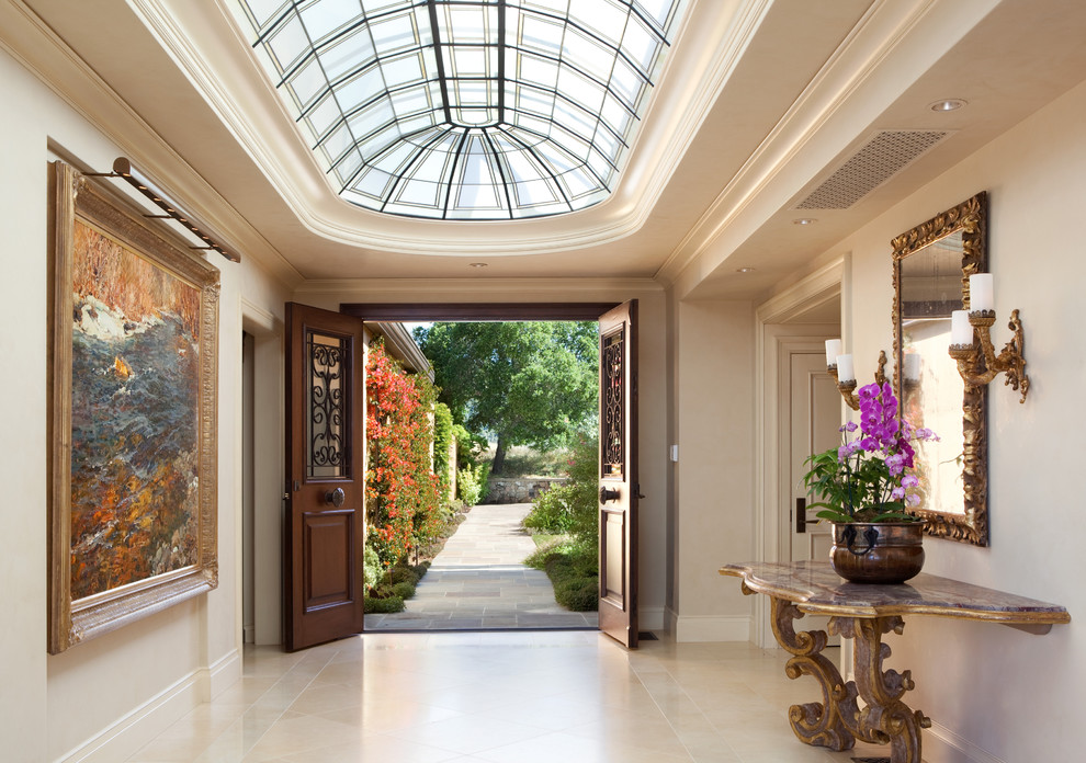 Inspiration for a mid-sized traditional foyer in San Francisco with white walls, a double front door, a dark wood front door, limestone floors and beige floor.