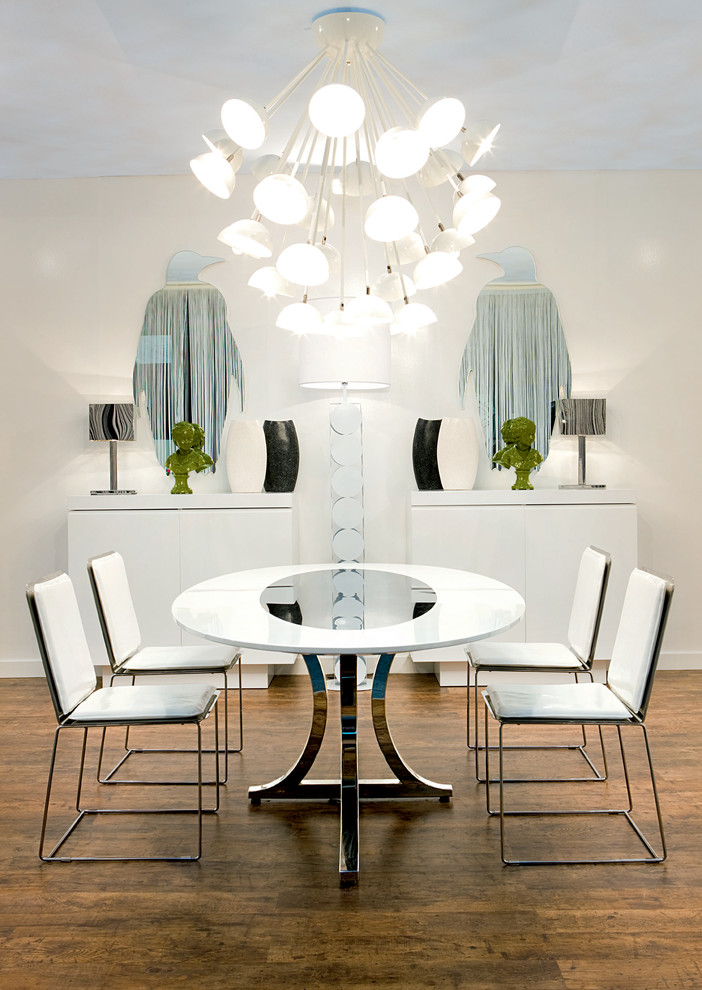 Contemporary dining room in Miami with dark hardwood floors and white walls.