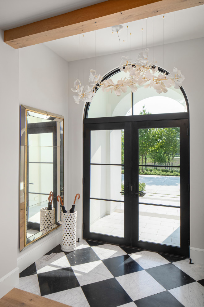 Photo of a traditional entrance in Minneapolis with white walls, a double front door and a black front door.