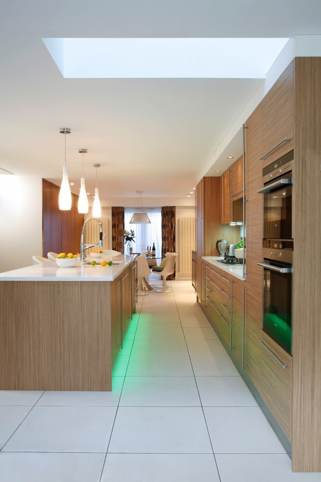 This is an example of a contemporary kitchen in London with panelled appliances.
